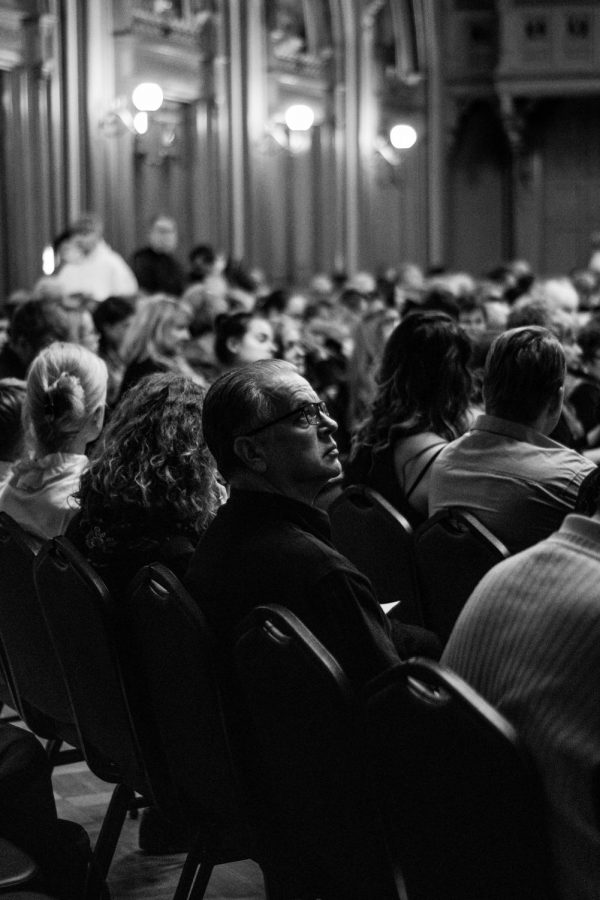 A photo of an audience at a formal ceremony.